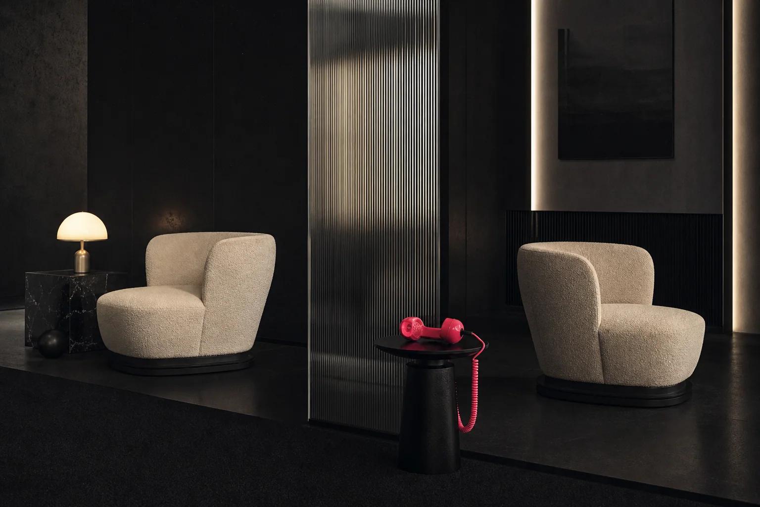 Two cream chairs divided by fluted glass with a disconnected pink telephone between them